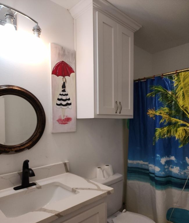 Bathroom featuring shower/tub combo, and vanity | Image 7