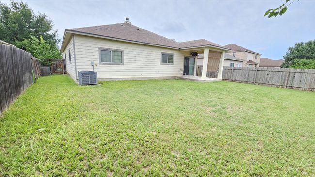 Rear view of house with a fenced backyard and a patio area | Image 10