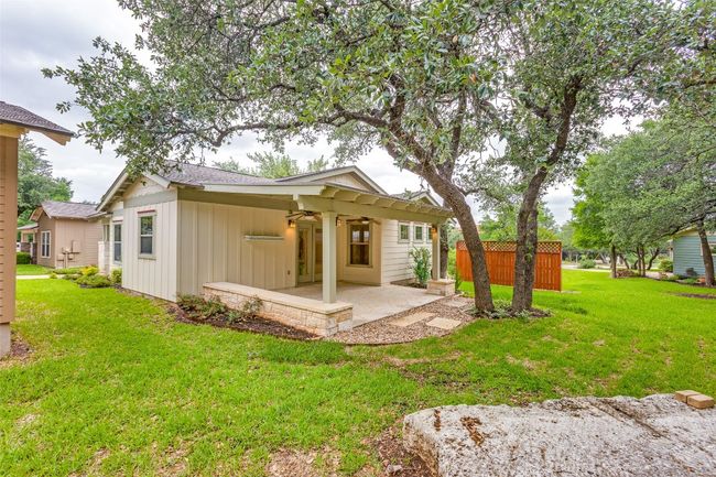 Rear view of house with a lawn, board and batten siding, a patio, ceiling fan, and roof with shingles | Image 31