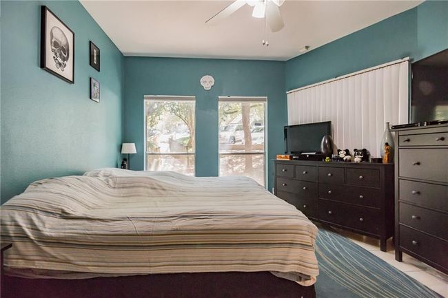 Bedroom featuring a ceiling fan | Image 14