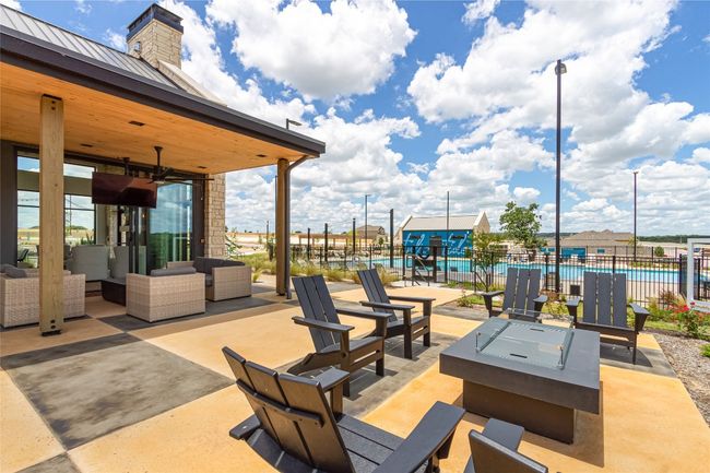 View of patio with an outdoor hangout area, a community pool, and ceiling fan | Image 38
