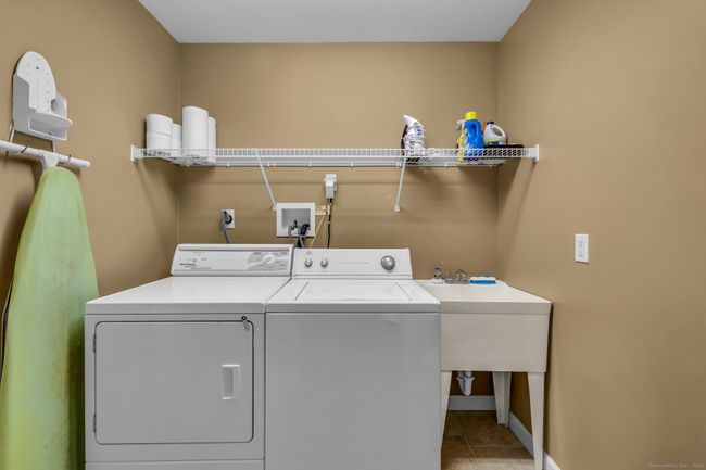 Laundry room off mudroom with utility sink. Washer and dryer convey with sale. | Image 14