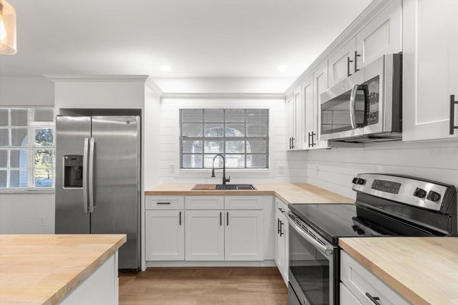 Renovated Kitchen with NEW: White Shaker Cabinets w/ Crown Molding & Lighting, Butcher Block Countertops, Shiplap Backsplash & Newer S/S Appliances | Image 19