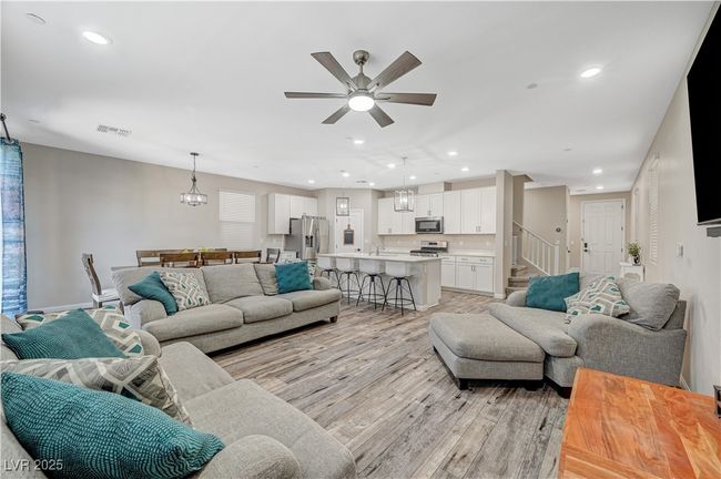 Living room featuring light wood-style floors, recessed lighting, ceiling fan, stairway, and baseboards | Image 14