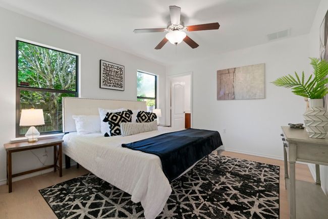 The primary suite is bright with natural light, and it includes an ensuite bathroom. | Image 12