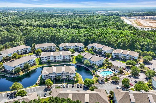 Bird's eye view of a heavily wooded area and a large body of water | Image 24