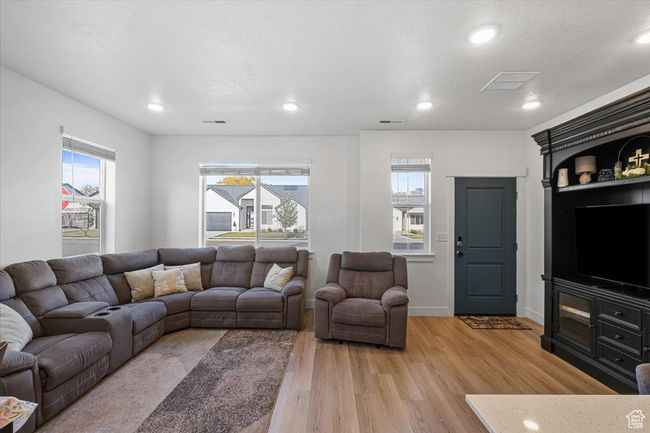 Living area with visible vents, light wood-style flooring, and recessed lighting | Image 5
