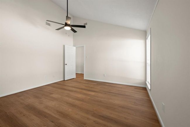 Secondary bedroom, New flooring, fresh paint, ceiling fans, updated lighting, and improved closet functionality. | Image 24