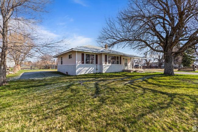 View of front facade with metal roof and a front lawn | Image 27