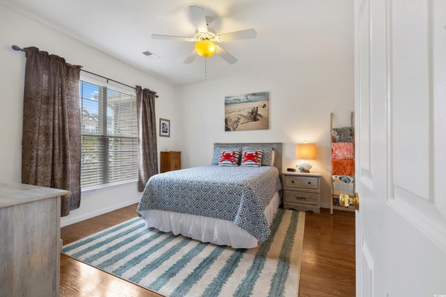Bedroom featuring baseboards, wood finished floors, and ceiling fan | Image 18
