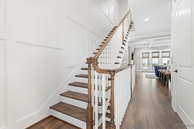Staircase featuring coffered ceiling, beam ceiling, wood finished floors, and recessed lighting | Image 21