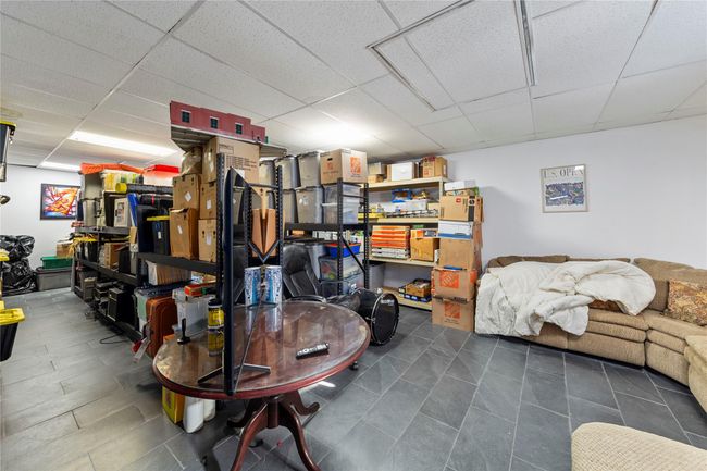 Basement featuring a paneled ceiling | Image 30