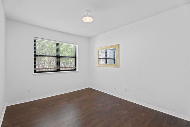 The secondary bedroom is well secluded apart from the primary suite for privacy. | Image 22