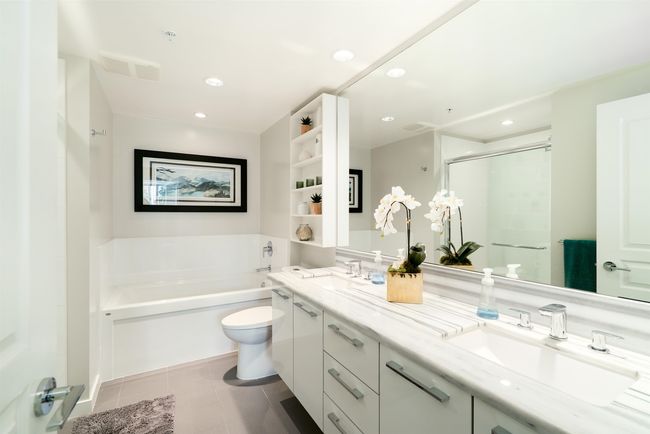 Bathroom featuring a garden tub, double vanity, tile patterned floors, toilet, and a shower stall | Image 21
