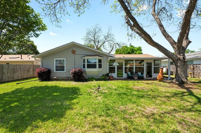Back of house featuring a sunroom, a yard, and fence | Image 25