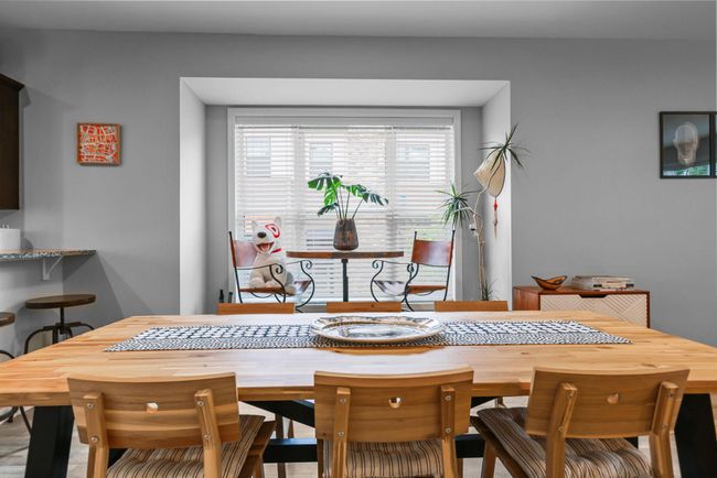 The dining room includes a large bay-style window that is not found in interior units. | Image 8