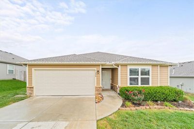 View of front of property with a front lawn and a garage | Image 1