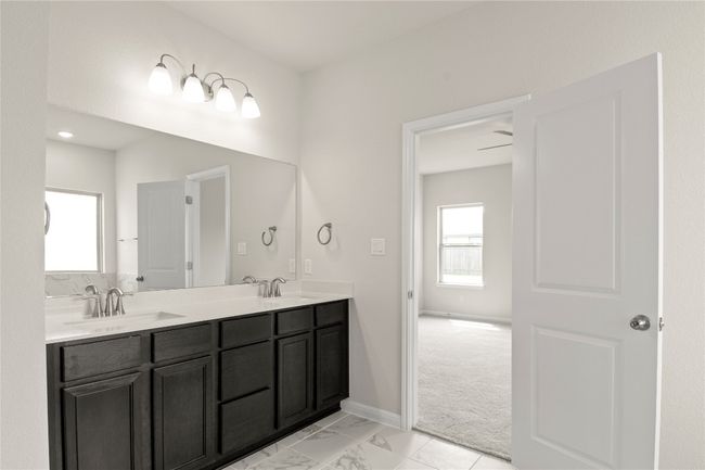 Full bath with double vanity and marble finish floors | Image 24
