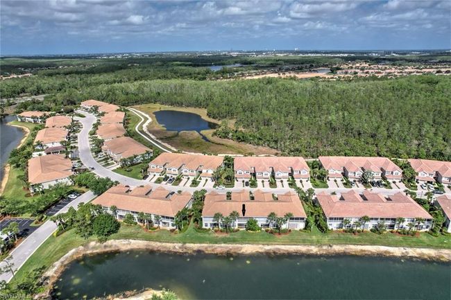 Drone / aerial view featuring a residential view, a water view, and a wooded view | Image 35