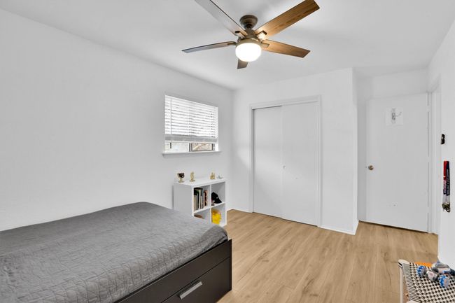 Bedroom with light wood-style flooring, a closet, and a ceiling fan | Image 24