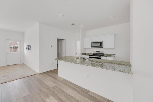 Ample cabinet space ensures that all your kitchen essentials have a home in this functional space. | Image 12