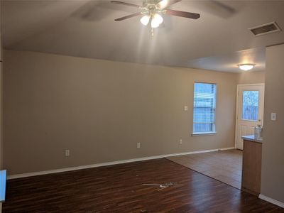 Spare room featuring dark wood-type flooring and ceiling fan | Image 2