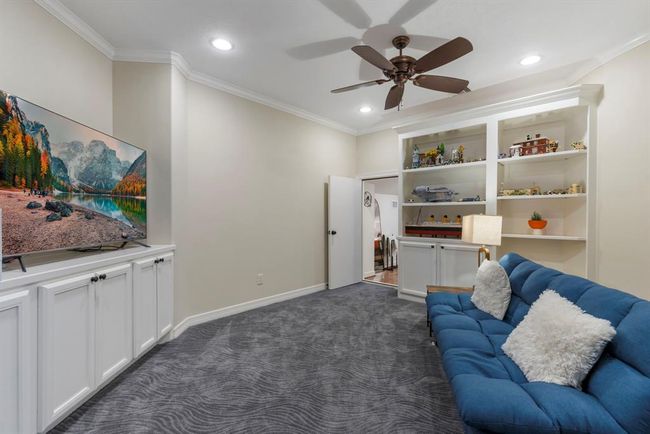 Inviting Family Playroom: A cozy space featuring plush seating, built-in storage, and a large screen for endless entertainment and play. | Image 29