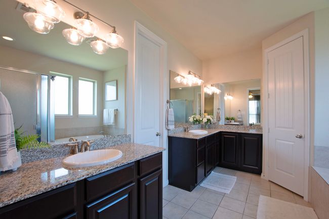 Bathroom featuring vanity, a bath, tile patterned floors, a stall shower, and a notable chandelier | Image 19