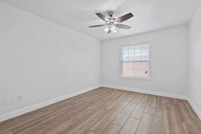 Spare room featuring light wood finished floors and a ceiling fan | Image 33
