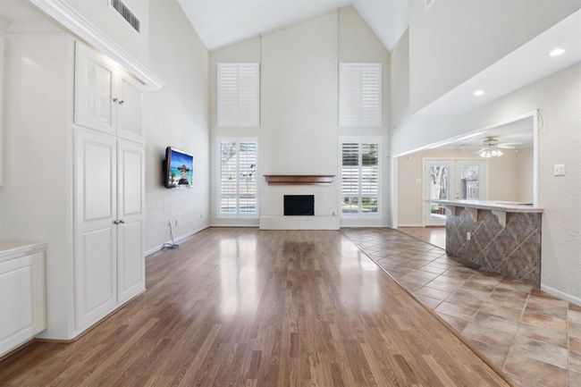 Living area offers fireplace and custom built-ins | Image 8