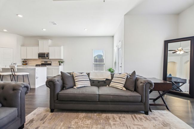 Living room with recessed lighting, visible vents, ceiling fan, and wood finished floors | Image 8