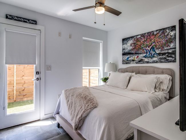 Tiled bedroom with multiple windows and ceiling fan | Image 15