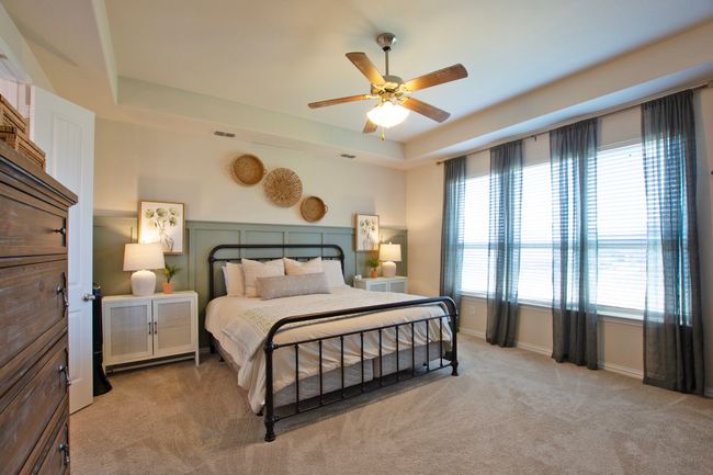 Bedroom with ceiling fan, visible vents, light colored carpet, baseboards, and a tray​​‌​​​​‌​​‌‌​‌‌​​​‌‌​​‌‌​‌​​​​​‌ ceiling | Image 17