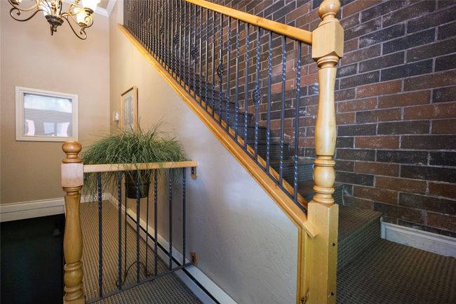 Stairway featuring a chandelier and baseboards | Image 25