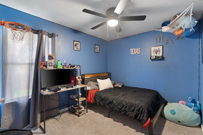 Carpeted bedroom featuring a ceiling fan | Image 20