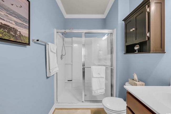 Bathroom with crown molding, a shower stall, and vanity | Image 18