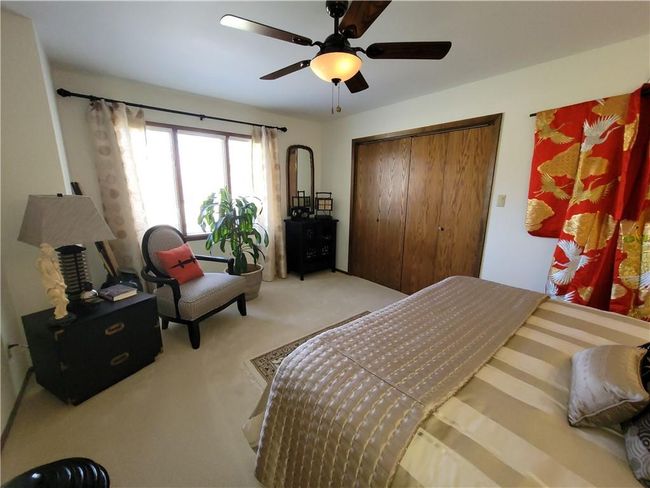 Carpeted bedroom with a closet and a ceiling fan | Image 44
