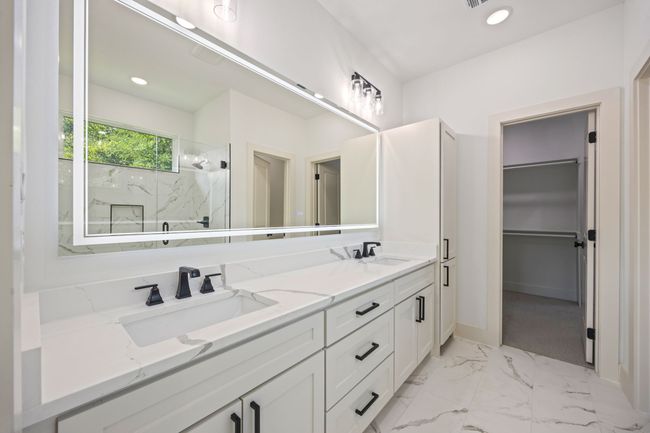 Full bath featuring a marble finish shower, double vanity, marble finish floors, baseboards, and recessed lighting | Image 18