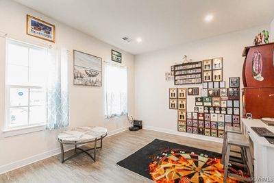 Living area featuring light hardwood / wood-style flooring and a healthy amount of sunlight | Image 3