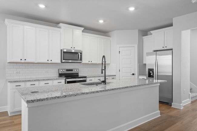 The fully loaded kitchen is a chef's paradise with granite countertops, stainless steel kitchen appliances and an abundance of storage. | Image 4