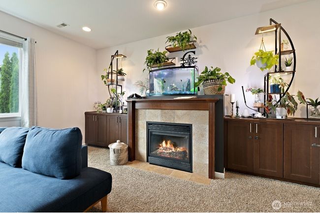 Cozy up by the gas fireplace, beautifully framed by built-in shelving and a stylish mantel—perfect for quiet evenings or holiday gatherings. | Image 11