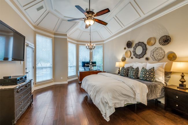 Bedroom featuring coffered ceiling, dark wood finished floors, a chandelier, crown molding, and baseboards | Image 20