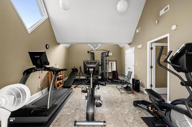 Workout area with high vaulted ceiling and baseboards | Image 21