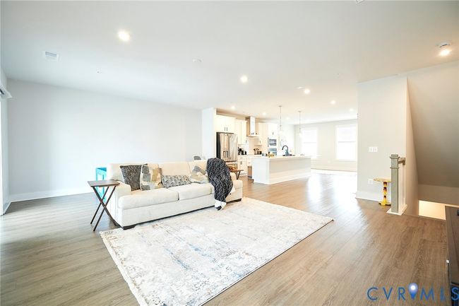 Living room featuring light wood-style flooring and recessed lighting | Image 35
