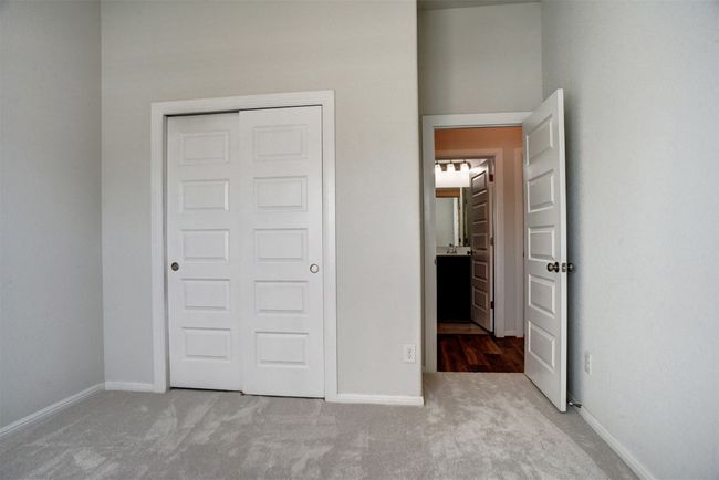 Unfurnished bedroom with baseboards, carpet flooring, and a closet | Image 28