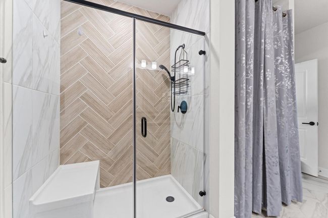 Spacious, glass-enclosed walk-in shower within the primary bathroom—designed for both comfort and future spa-like upgrades. | Image 14
