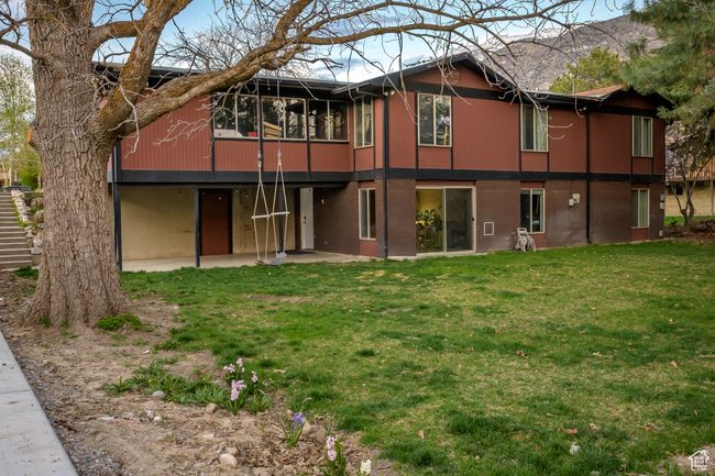 Rear view of property with a yard, brick siding, and a patio area | Image 25