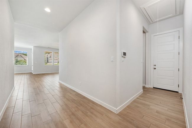 Hallway featuring attic access. | Image 24
