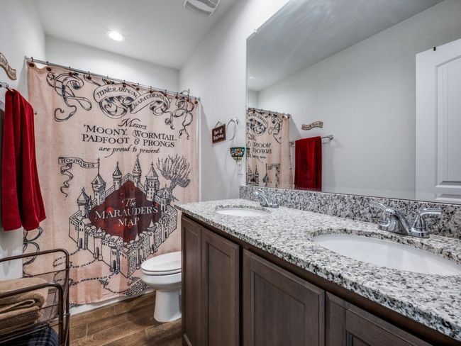 Full bath with wood finished floors, double vanity, recessed lighting, and a shower with shower curtain | Image 22