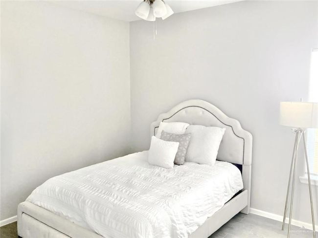 Unfurnished bedroom featuring wood finished floors, a closet, and ceiling fan | Image 7